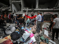 Palestinians are checking the damage in a house that was destroyed by an overnight Israeli bombardment in Nuseirat camp in the central Gaza...