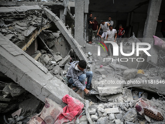 Palestinians are checking the damage in a house that was destroyed by an overnight Israeli bombardment in Nuseirat camp in the central Gaza...