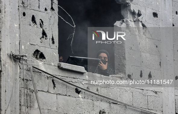 A Palestinian is inspecting the damage in a house that was destroyed by an overnight Israeli bombardment in Nuseirat camp in the central Gaz...