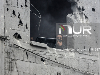 A Palestinian is inspecting the damage in a house that was destroyed by an overnight Israeli bombardment in Nuseirat camp in the central Gaz...