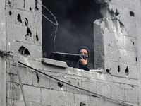 A Palestinian is inspecting the damage in a house that was destroyed by an overnight Israeli bombardment in Nuseirat camp in the central Gaz...