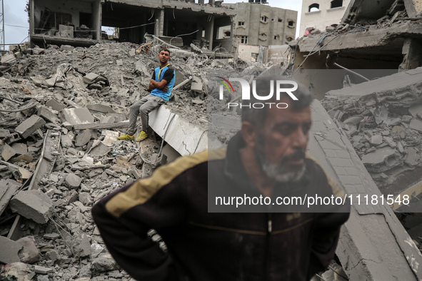 Palestinians are checking the damage in a house that was destroyed by an overnight Israeli bombardment in Nuseirat camp in the central Gaza...