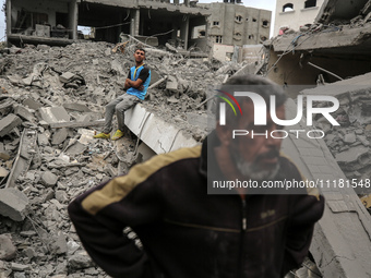 Palestinians are checking the damage in a house that was destroyed by an overnight Israeli bombardment in Nuseirat camp in the central Gaza...