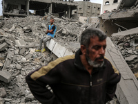 Palestinians are checking the damage in a house that was destroyed by an overnight Israeli bombardment in Nuseirat camp in the central Gaza...