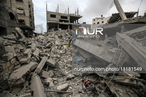 A Palestinian is inspecting the damage in a house that was destroyed by an overnight Israeli bombardment in Nuseirat camp in the central Gaz...