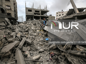 A Palestinian is inspecting the damage in a house that was destroyed by an overnight Israeli bombardment in Nuseirat camp in the central Gaz...