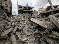 A Palestinian is inspecting the damage in a house that was destroyed by an overnight Israeli bombardment in Nuseirat camp in the central Gaz...