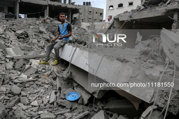 A Palestinian is inspecting the damage in a house that was destroyed by an overnight Israeli bombardment in Nuseirat camp in the central Gaz...