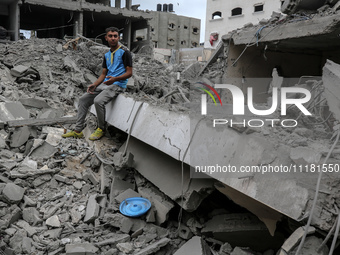 A Palestinian is inspecting the damage in a house that was destroyed by an overnight Israeli bombardment in Nuseirat camp in the central Gaz...