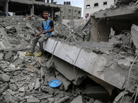 A Palestinian is inspecting the damage in a house that was destroyed by an overnight Israeli bombardment in Nuseirat camp in the central Gaz...