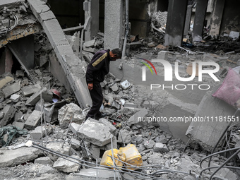 A Palestinian is inspecting the damage in a house that was destroyed by an overnight Israeli bombardment in Nuseirat camp in the central Gaz...