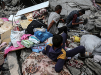 Palestinians are checking the damage in a house that was destroyed by an overnight Israeli bombardment in Nuseirat camp in the central Gaza...