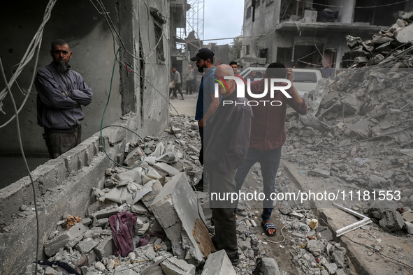 Palestinians are checking the damage in a house that was destroyed by an overnight Israeli bombardment in Nuseirat camp in the central Gaza...