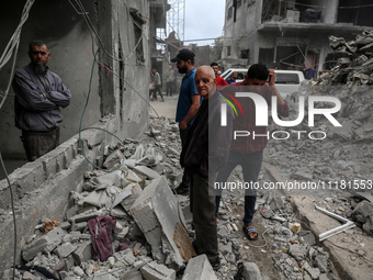 Palestinians are checking the damage in a house that was destroyed by an overnight Israeli bombardment in Nuseirat camp in the central Gaza...