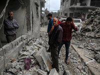 Palestinians are checking the damage in a house that was destroyed by an overnight Israeli bombardment in Nuseirat camp in the central Gaza...