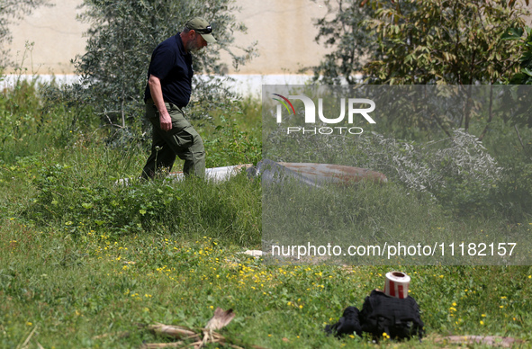 Simon Elmont from Humanity and Inclusion UK is examining and tagging large Israeli unexploded weapons to try to ensure maximum safety in Dei...