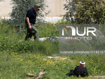 Simon Elmont from Humanity and Inclusion UK is examining and tagging large Israeli unexploded weapons to try to ensure maximum safety in Dei...