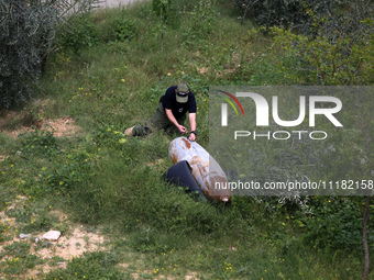 Simon Elmont from Humanity and Inclusion UK is examining and tagging large Israeli unexploded weapons to try to ensure maximum safety in Dei...