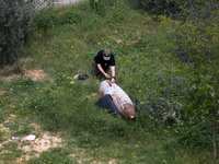 Simon Elmont from Humanity and Inclusion UK is examining and tagging large Israeli unexploded weapons to try to ensure maximum safety in Dei...