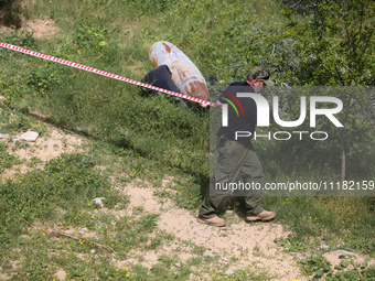 Simon Elmont from Humanity and Inclusion UK is examining and tagging large Israeli unexploded weapons to try to ensure maximum safety in Dei...