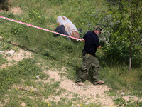 Simon Elmont from Humanity and Inclusion UK is examining and tagging large Israeli unexploded weapons to try to ensure maximum safety in Dei...