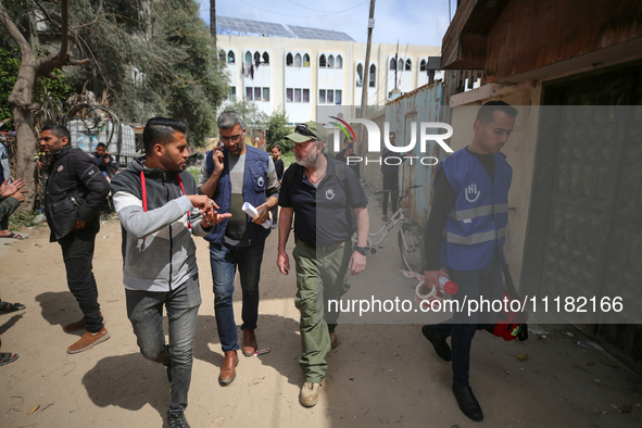 Simon Elmont from Humanity and Inclusion UK is examining and tagging large Israeli unexploded weapons to try to ensure maximum safety in Dei...