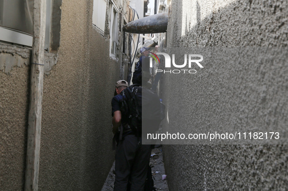 Members of Humanity and Inclusion UK are examining and marking significant Israeli unexploded weapons to try to ensure maximum safety in Dei...