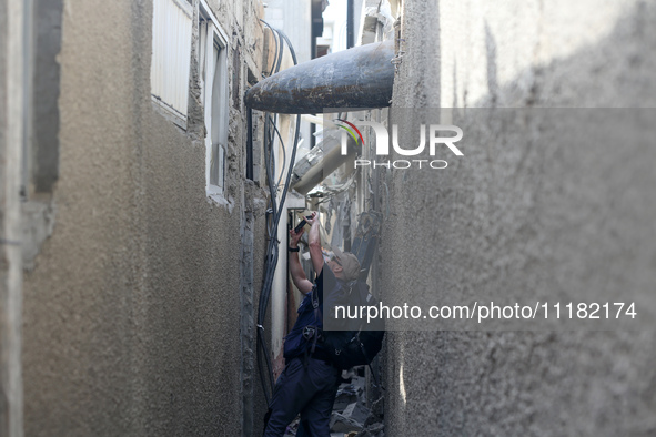 Members of Humanity and Inclusion UK are examining and marking significant Israeli unexploded weapons to try to ensure maximum safety in Dei...