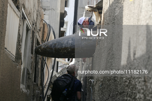 Members of Humanity and Inclusion UK are examining and marking significant Israeli unexploded weapons to try to ensure maximum safety in Dei...