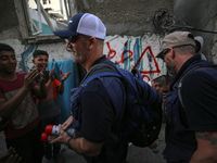 Members of Humanity and Inclusion UK are examining and marking significant Israeli unexploded weapons to try to ensure maximum safety in Dei...