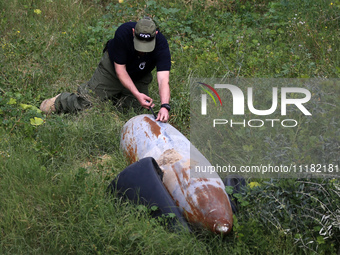 Simon Elmont from Humanity and Inclusion UK is examining and tagging large Israeli unexploded weapons to try to ensure maximum safety in Dei...