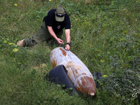 Simon Elmont from Humanity and Inclusion UK is examining and tagging large Israeli unexploded weapons to try to ensure maximum safety in Dei...