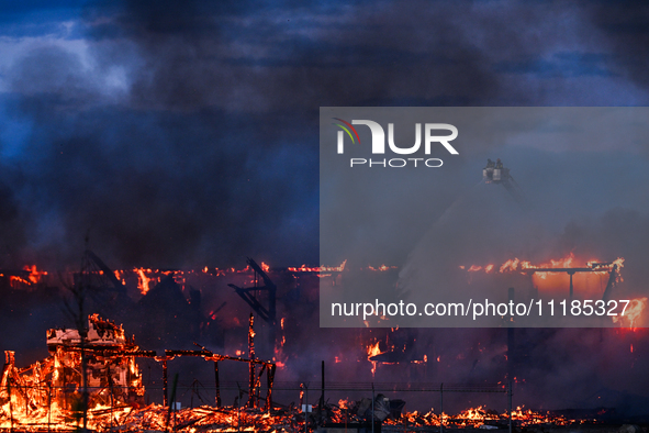 EDMONTON, CANADA - APRIL 22:
Several units of firefighters combat flames that tore through Edmonton's historic Hangar 11 on Monday evening,...