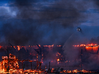 EDMONTON, CANADA - APRIL 22:
Several units of firefighters combat flames that tore through Edmonton's historic Hangar 11 on Monday evening,...