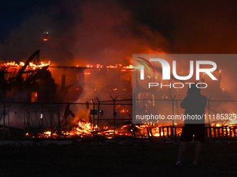 EDMONTON, CANADA - APRIL 22:
A person approaches the fire site, risking his health as several units of firefighters combat the flames that t...