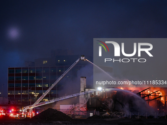 EDMONTON, CANADA - APRIL 22:
Several units of firefighters combat flames that tore through Edmonton's historic Hangar 11 on Monday evening,...