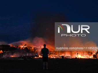 EDMONTON, CANADA - APRIL 22:
A person approaches the fire site, risking his health as several units of firefighters combat the flames that t...