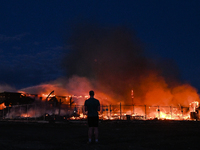 EDMONTON, CANADA - APRIL 22:
A person approaches the fire site, risking his health as several units of firefighters combat the flames that t...