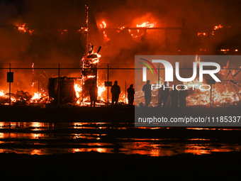 EDMONTON, CANADA - APRIL 22:
People approach the fire site, risking their health as several units of firefighters combat the flames that tor...