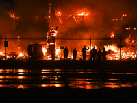 EDMONTON, CANADA - APRIL 22:
People approach the fire site, risking their health as several units of firefighters combat the flames that tor...