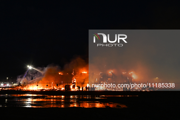 EDMONTON, CANADA - APRIL 22:
People approach the fire site, risking their health as several units of firefighters combat the flames that tor...