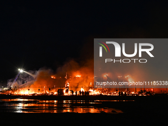 EDMONTON, CANADA - APRIL 22:
People approach the fire site, risking their health as several units of firefighters combat the flames that tor...