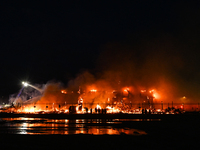 EDMONTON, CANADA - APRIL 22:
People approach the fire site, risking their health as several units of firefighters combat the flames that tor...