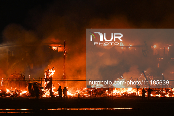 EDMONTON, CANADA - APRIL 22:
People approach the fire site, risking their health as several units of firefighters combat the flames that tor...