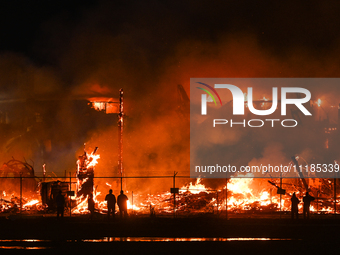 EDMONTON, CANADA - APRIL 22:
People approach the fire site, risking their health as several units of firefighters combat the flames that tor...