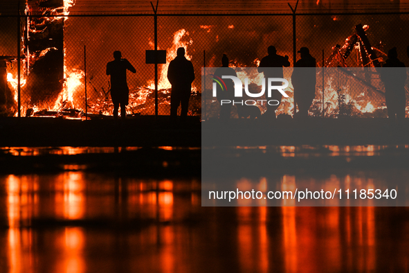 EDMONTON, CANADA - APRIL 22:
People approach the fire site, risking their health as several units of firefighters combat the flames that tor...