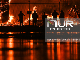 EDMONTON, CANADA - APRIL 22:
People approach the fire site, risking their health as several units of firefighters combat the flames that tor...