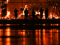 EDMONTON, CANADA - APRIL 22:
People approach the fire site, risking their health as several units of firefighters combat the flames that tor...