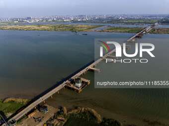 Workers are carrying out the construction of the steel pier bridge and the lower structure of the bridge across three river sections at the...