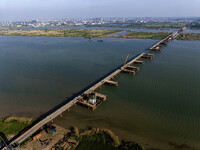 Workers are carrying out the construction of the steel pier bridge and the lower structure of the bridge across three river sections at the...